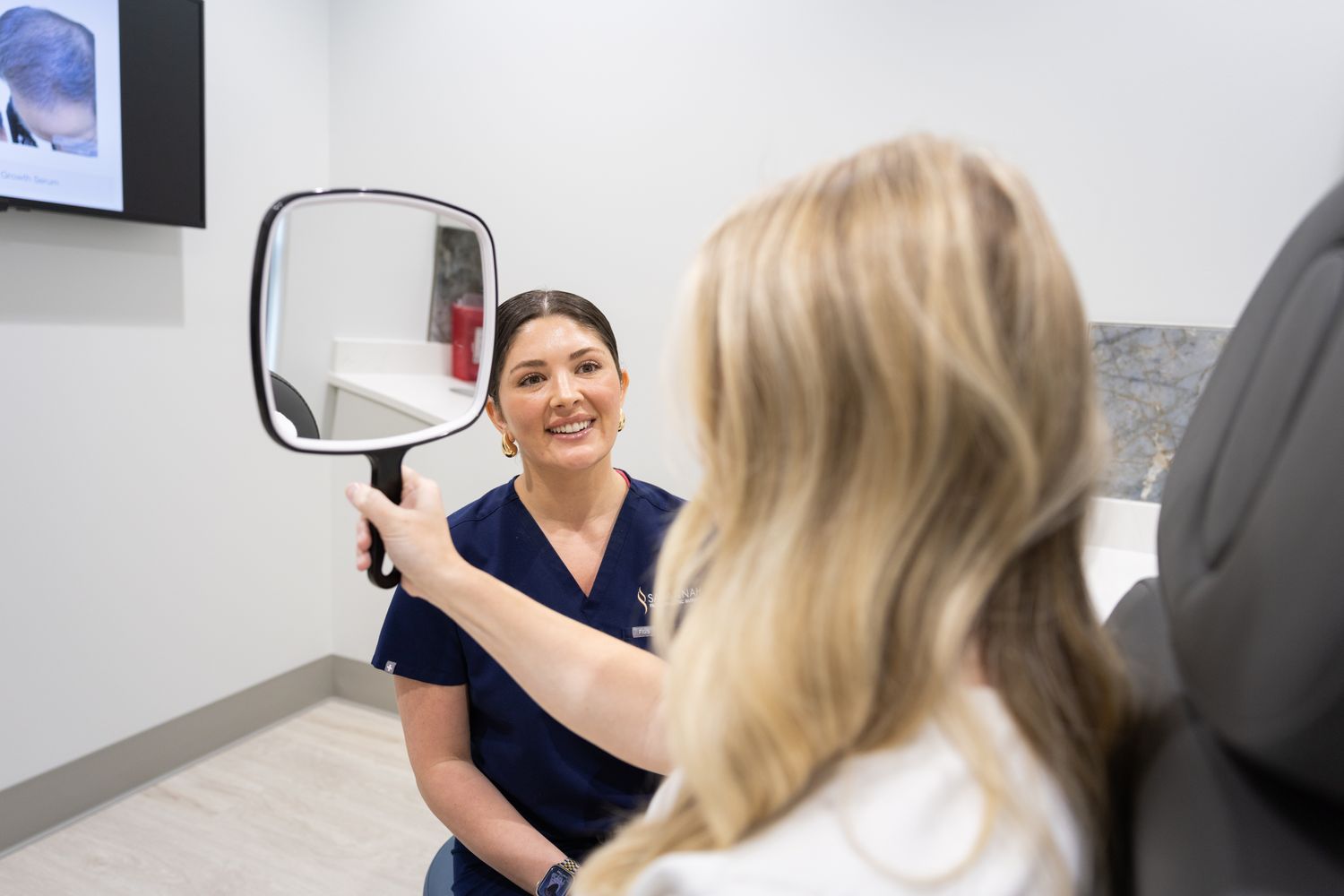 Patient smiling while consulting with medical professional.